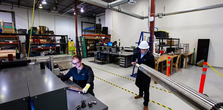 Photo of an engineer in the shop, working on a tool.